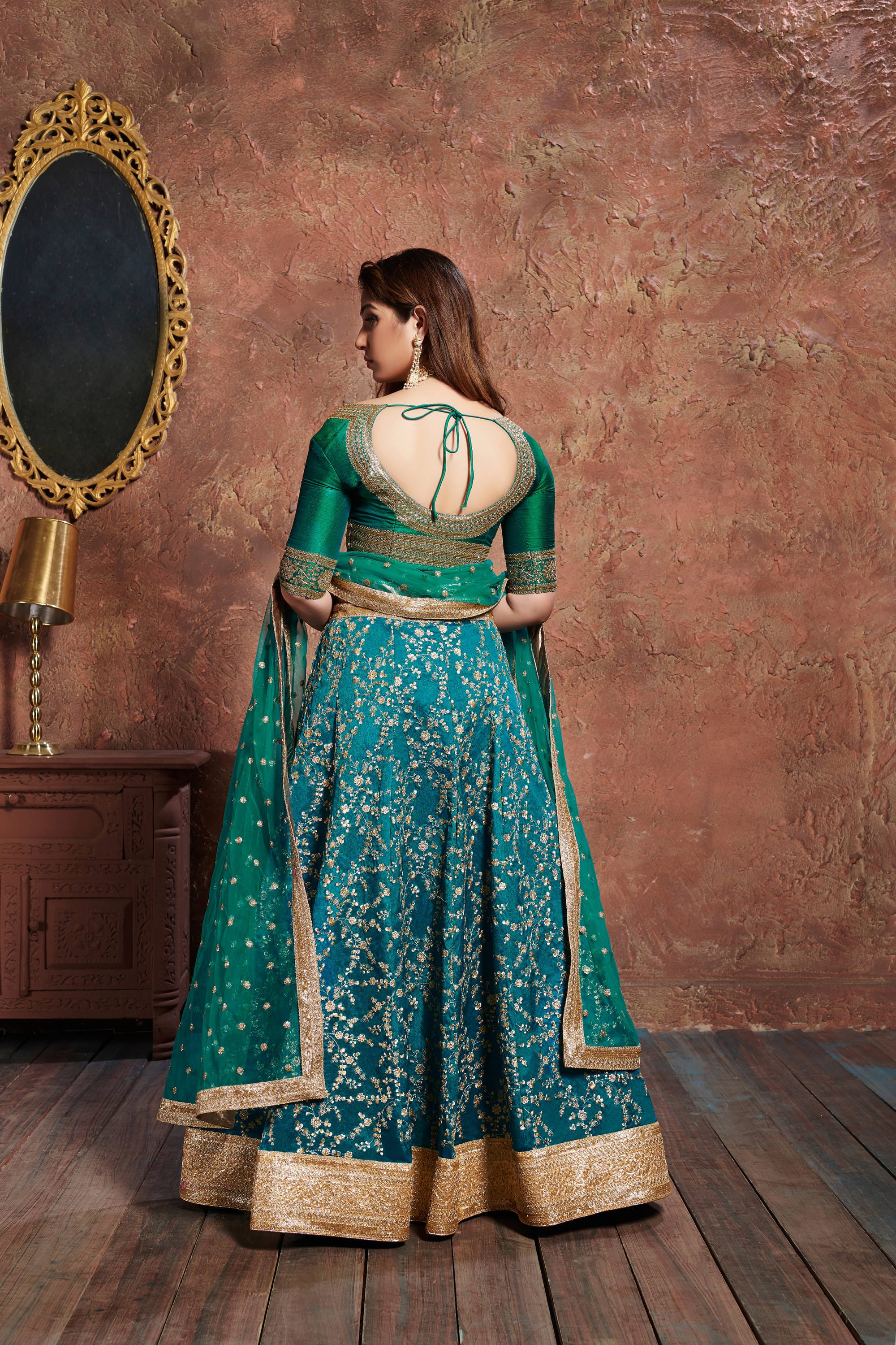 Turquoise Elegance: Lehenga Choli adorned with Zari, Sequins, and Dori Embroidery