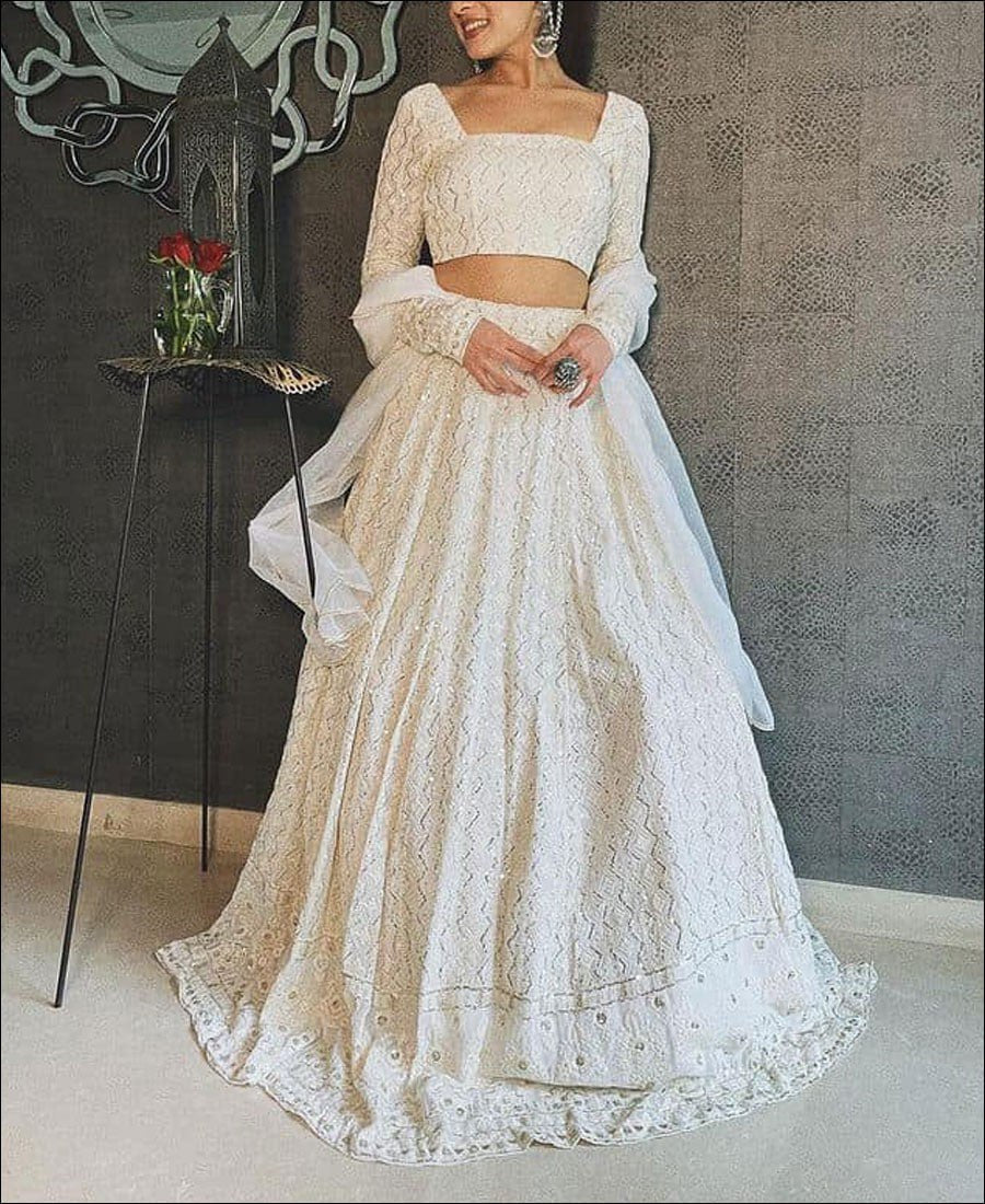 Elegant White Lehenga Choli adorned with Intricate Multi-Thread Sequin Embroidery on Luxurious Faux Georgette